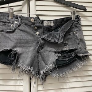 Free People black denim frayed shorts.